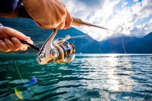 woman-fishing-on-fishing-rod-spinning-in-norway.jpg